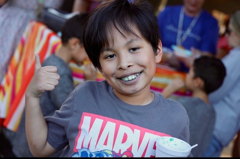 Student enjoying the celebration and raspados.