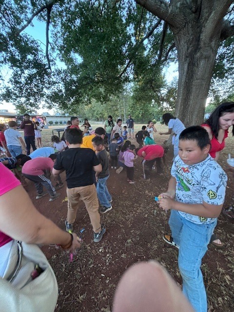 Students grabbing candy from the pinata.