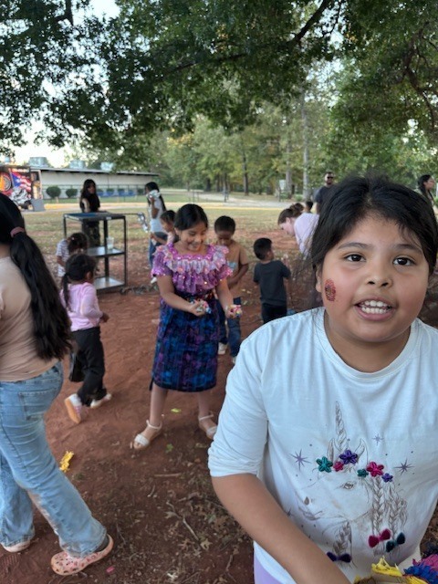 Students gathering candy from the pinatas.