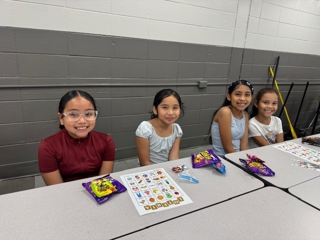 Students in third and fifth graders playing loteria together.