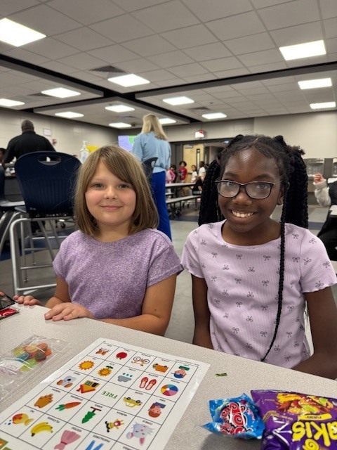 Two students playing loteria together and having so much fun.