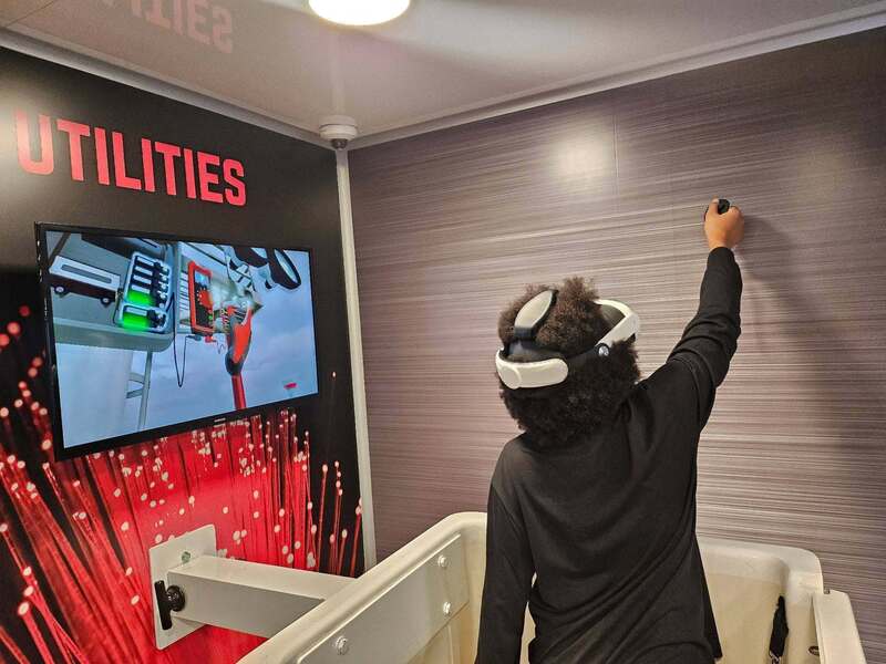 A student wears a VR headset and learns about careers i.n Utilities