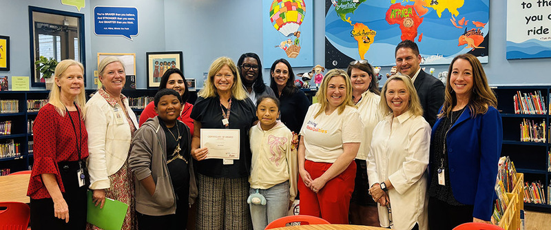 Principal Sutton & other Montview staff pose with district staff and Toyota Reps as they accept their grant certificate