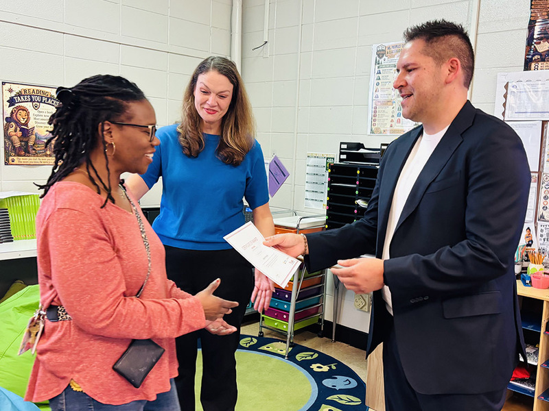 Principal Thompson & Toyota Rep present Dawson teacher with grant certificate
