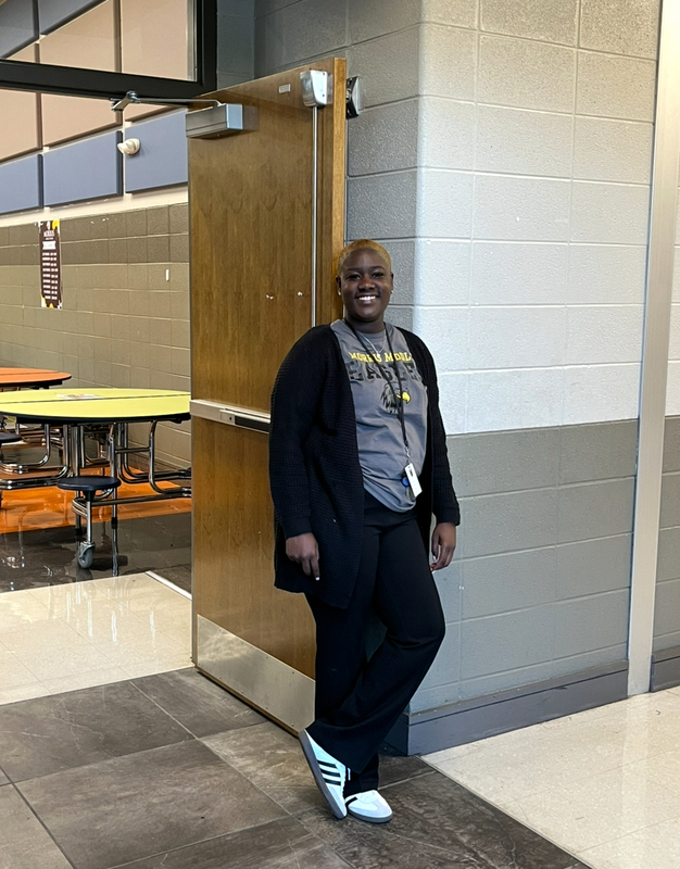 Assistant Principal Williams poses in front of the cafeteria door.