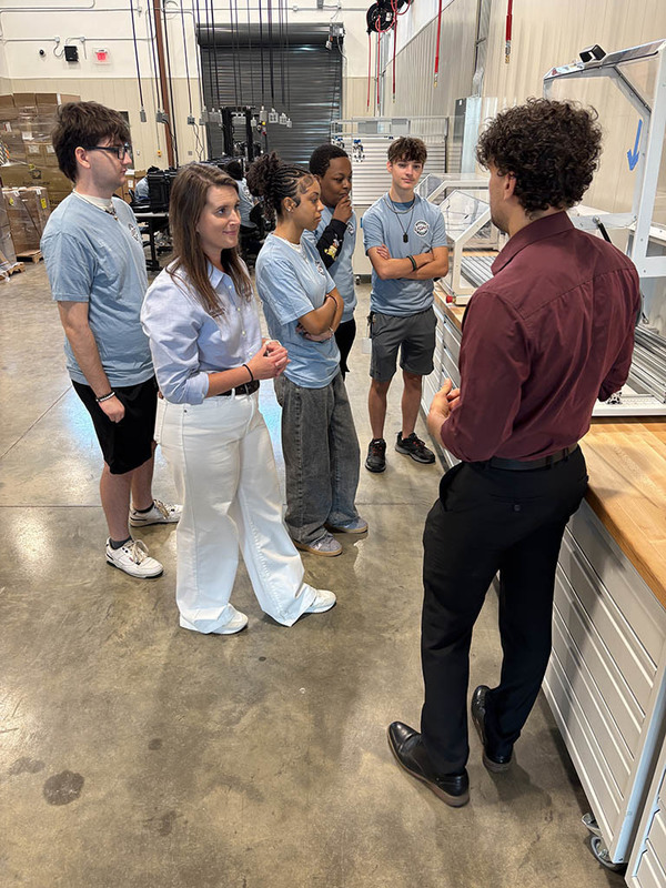 LIGHT instructors showing equipment to a group of students