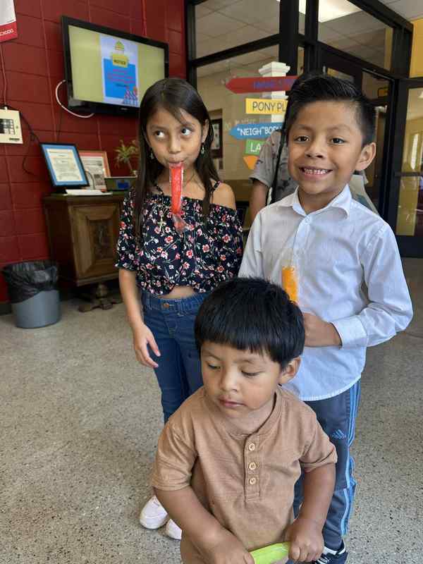 Photo of a 2nd grader and 3rd grader with their popsicles.