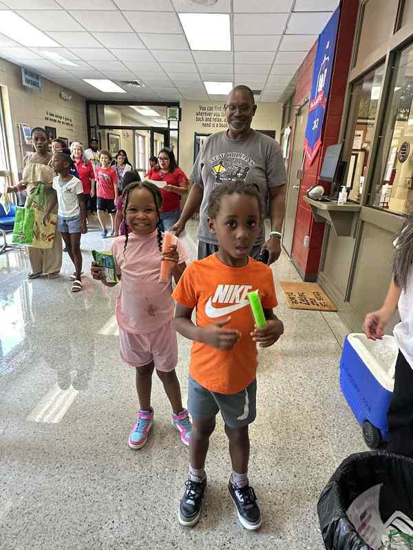 Photo of a family with students going into 2nd grade and kindergarten.