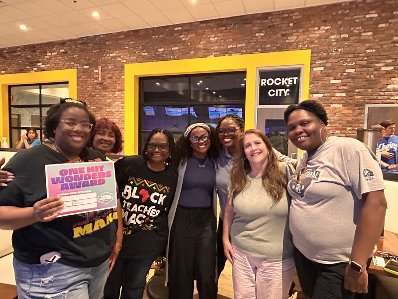 At the Main Event, staff gathers together for a picture to display their award as the "One Hit Wonders" after completing the bowling challenges.