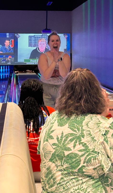 Ms. Compher shows her excited at the Main Event after bowling a strike.