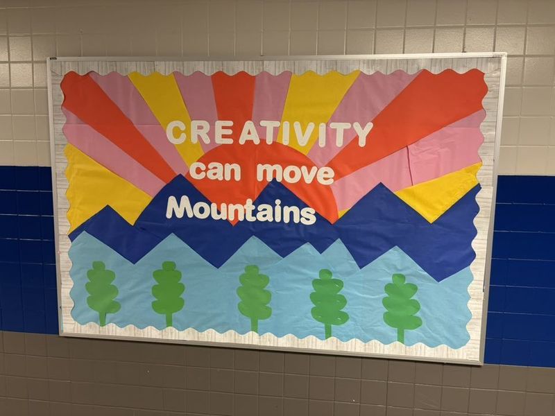 Our amazing art teacher created this colorful bulletin board with the words Creativity Can Move Mountains