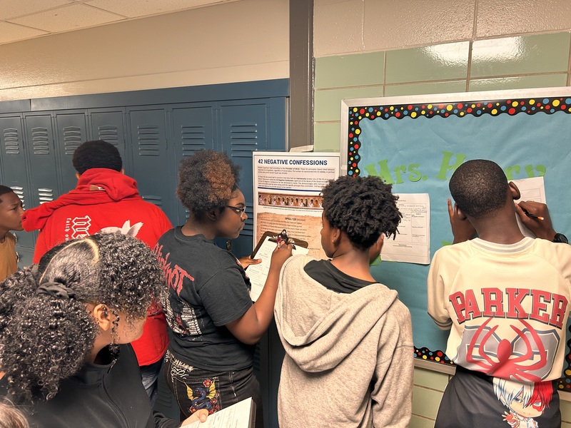 Students are working in a group in the hallway to explore Egyptian Afterlife.