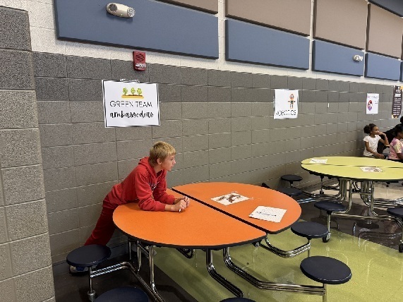 A member of the Green Ambassadors waits for the Club Fair to start