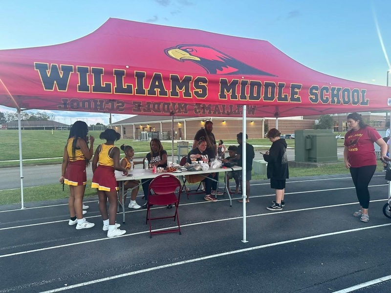 Students and teachers under the Williams Middle School Tent on the Track
