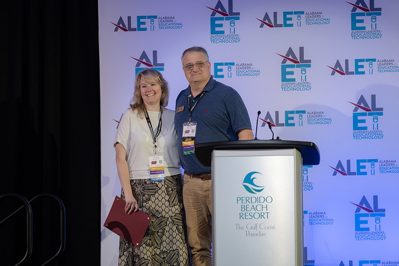 Emily Elam posing with ALET representative after receiving award