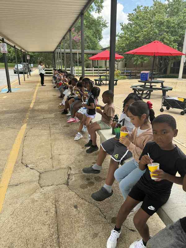 All the first grade students enjoying their Kona Ice.