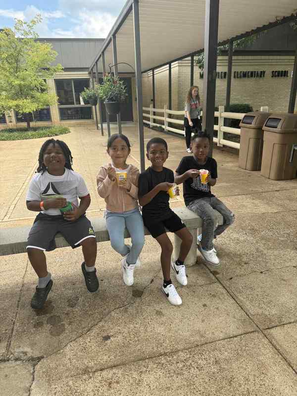 Students are happy and smiling eating their Kona Ice