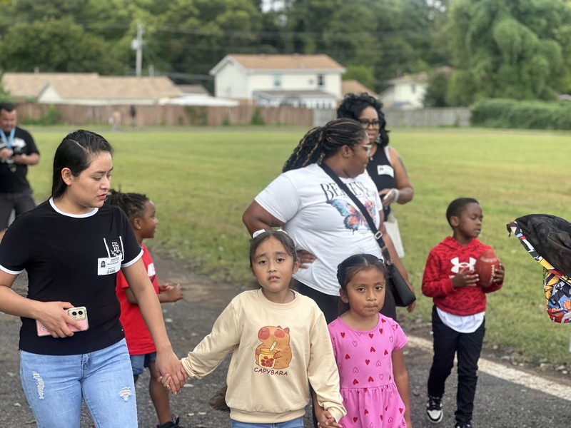 Parents and students walking on the track.
