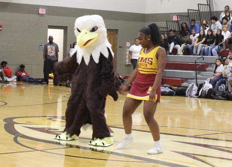 "Morris the Eagle", our new mascot dances with a cheerleader