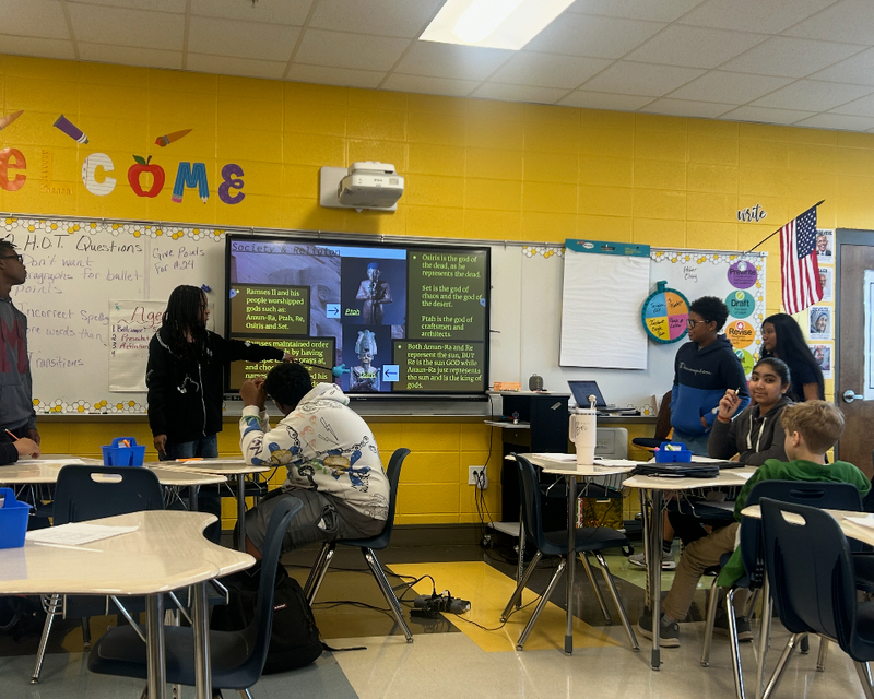 Mrs. Peete's students watch as Adriel Rodriguez presents her research
