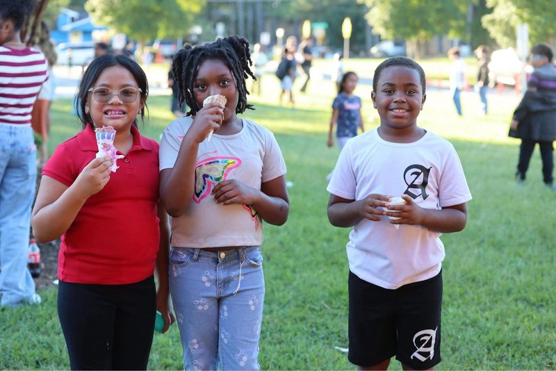 Students enjoying ice cream treats at the celebration.