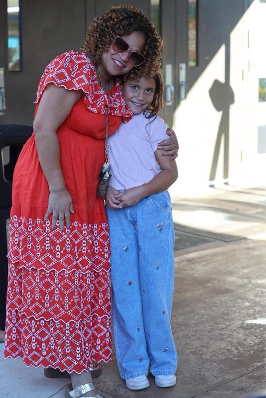 Ms. Johnson and student hugging at the celebration.