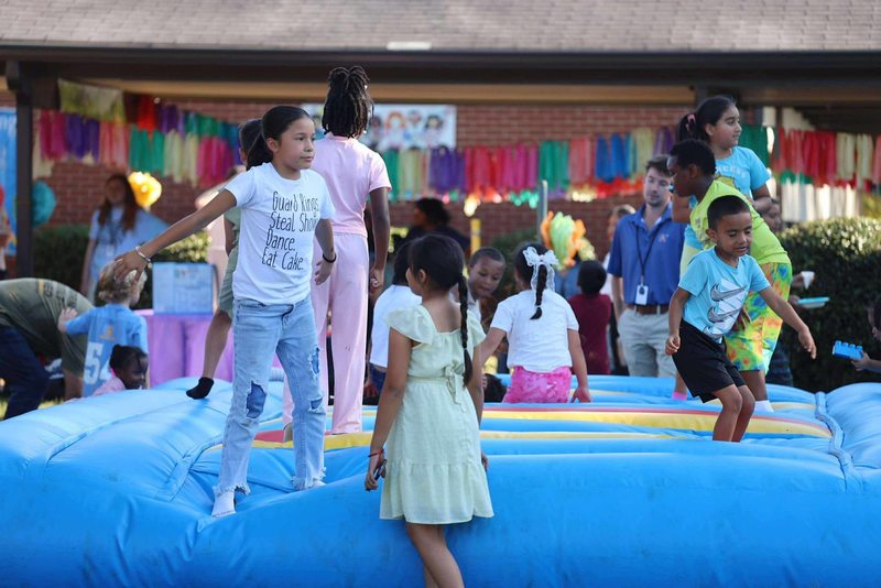 Students jumping on the bounce pad.
