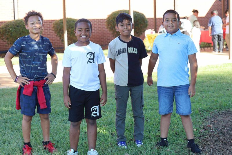 Four students smiling for the camera.
