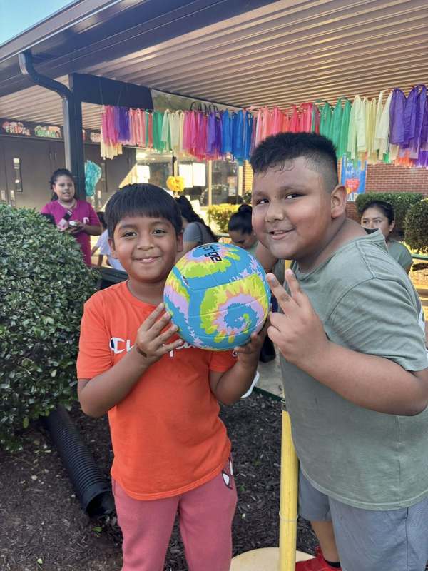 Student who won a soccer ball in Loteria and friend.