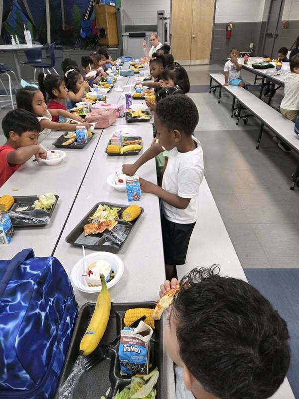 A preschool class digging into their celebratory sundaes at the lunch table!