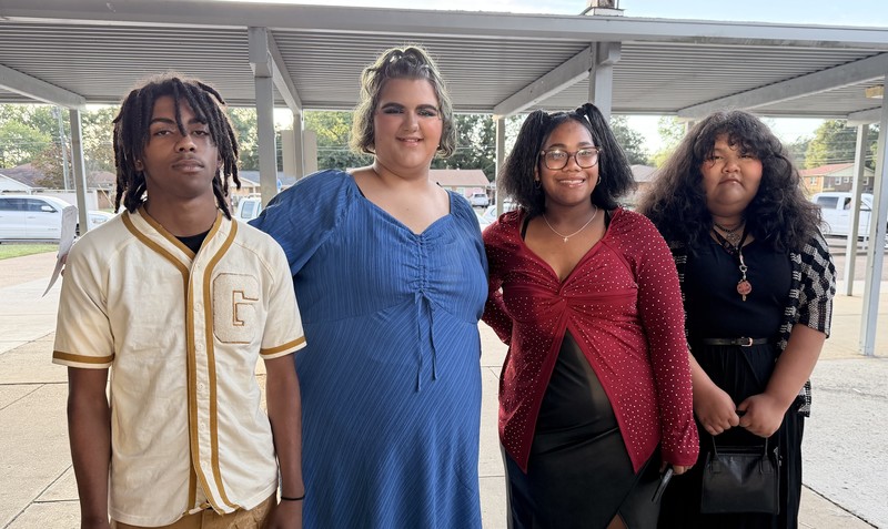 Students are dressed in their best semi-formal attire for a fun night at the Homecoming Dance. The students are outside, enjoying fresh air at the start of the dance.