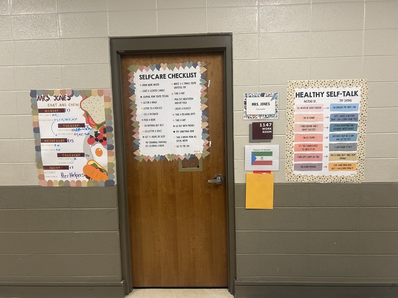 A door surrounded by posters featuring slef care tips and changing self-talk to positives