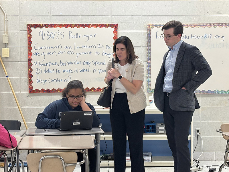 Mazda Foundation representatives observing a student working on a computer