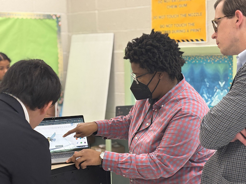 Mazda foundation reps observing a teacher showing CAD design