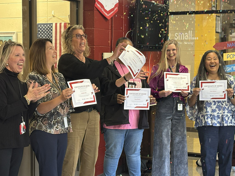 School administrators popping confetti as they receive certificates from Toyota AL