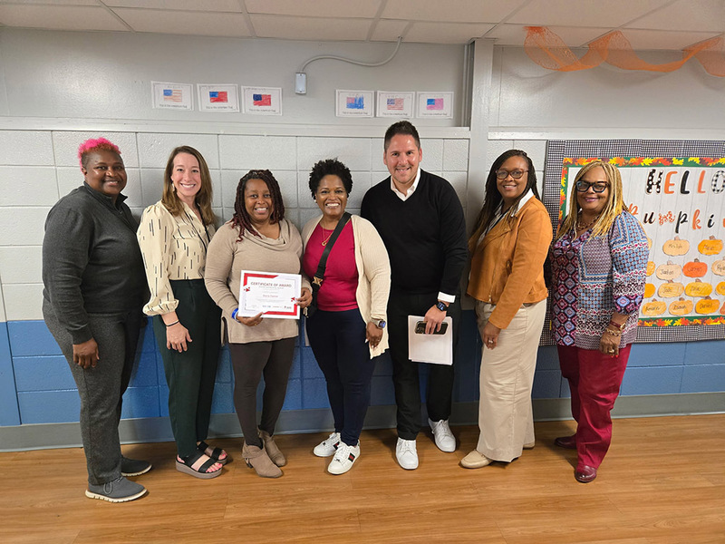 Toyota AL representatives pose with school and district leaders at  a Huntsville City School