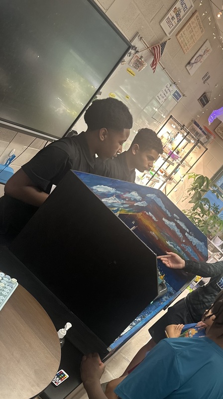 In a classroom, students from Future City engage families by presenting their project, the City of Milele.