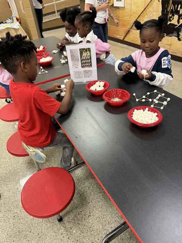 1st grade students building with toothpicks and marshmallows.