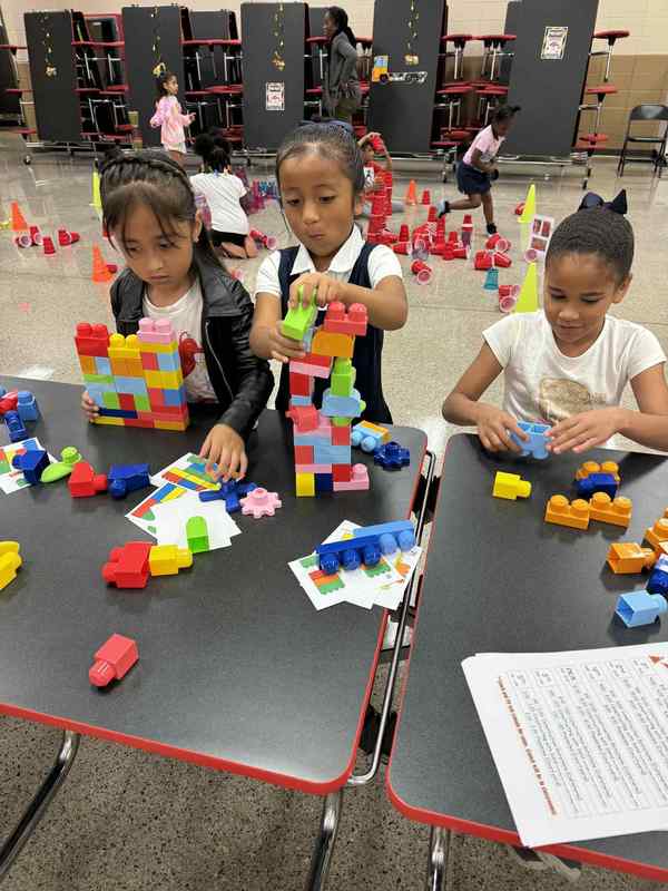 1st grade students building with legos.
