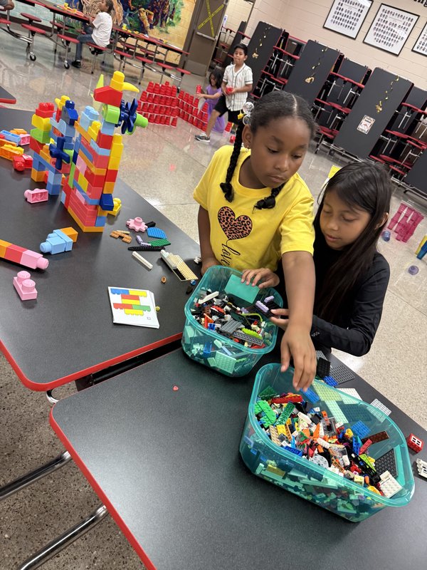 3rd grade students building with legos.