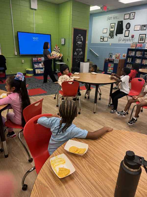Students in the library listening to Pepe and the Parade with chips and queso.
