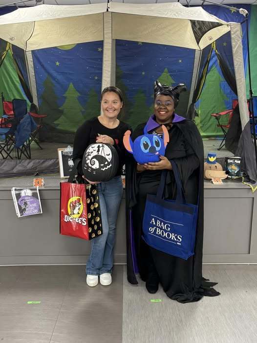 Ms. Treece and Ms, Ector holding their prizes and their prize-winning pumpkins.