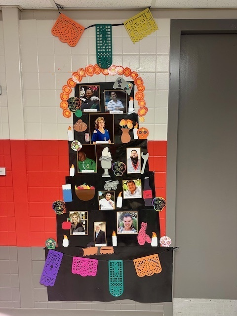 The Ridgecrest Ofrenda with photographs of family members and items that they enjoyed., as well as decorations for Dia de los Muertos.