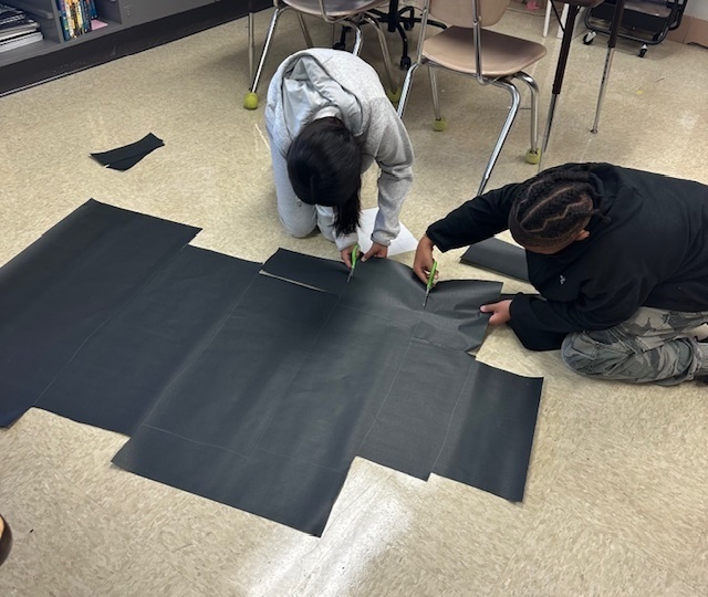 Students creating the ofrenda for Dia de los Muertos.
