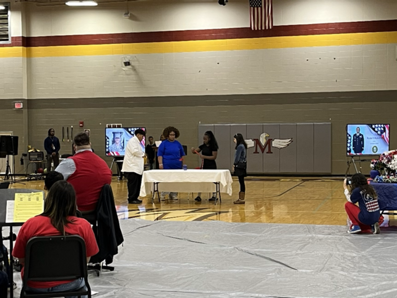 Students set the symbolic table