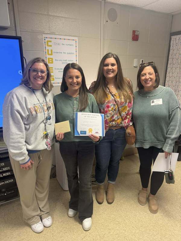 Mrs. Treece receiving her award for Teacher of the Month, surrounded by our assistant principal and community partners.