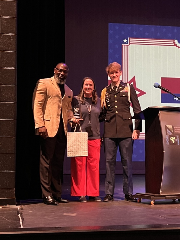 Ms. White and the JROTC Batallion Commander pose with guest speaker Mr. Irvin.