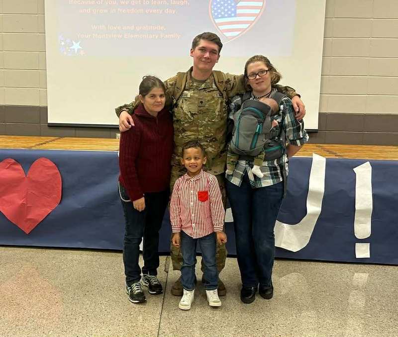 Jeremiah and his family with one member that is in military uniform.
