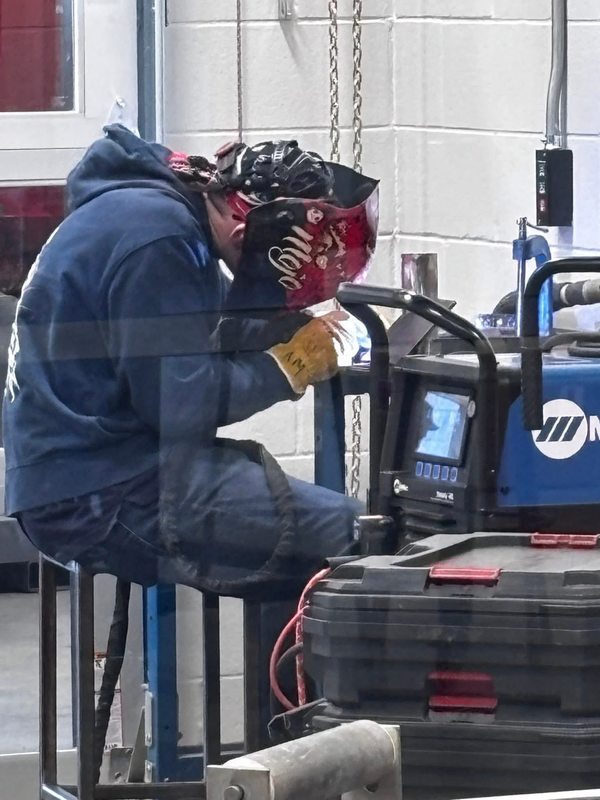 Student welding at the competition