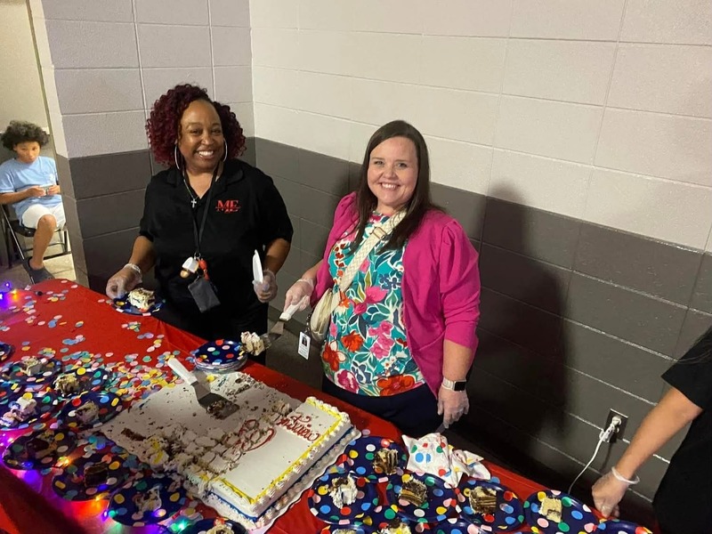 Our reading coach, Dawn Thomas, and Instructional Mentoring Coach, Kim Deem helping give out the cake.